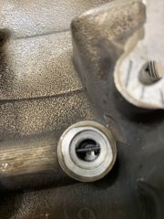 Wet sump check valve machined into timing cover?